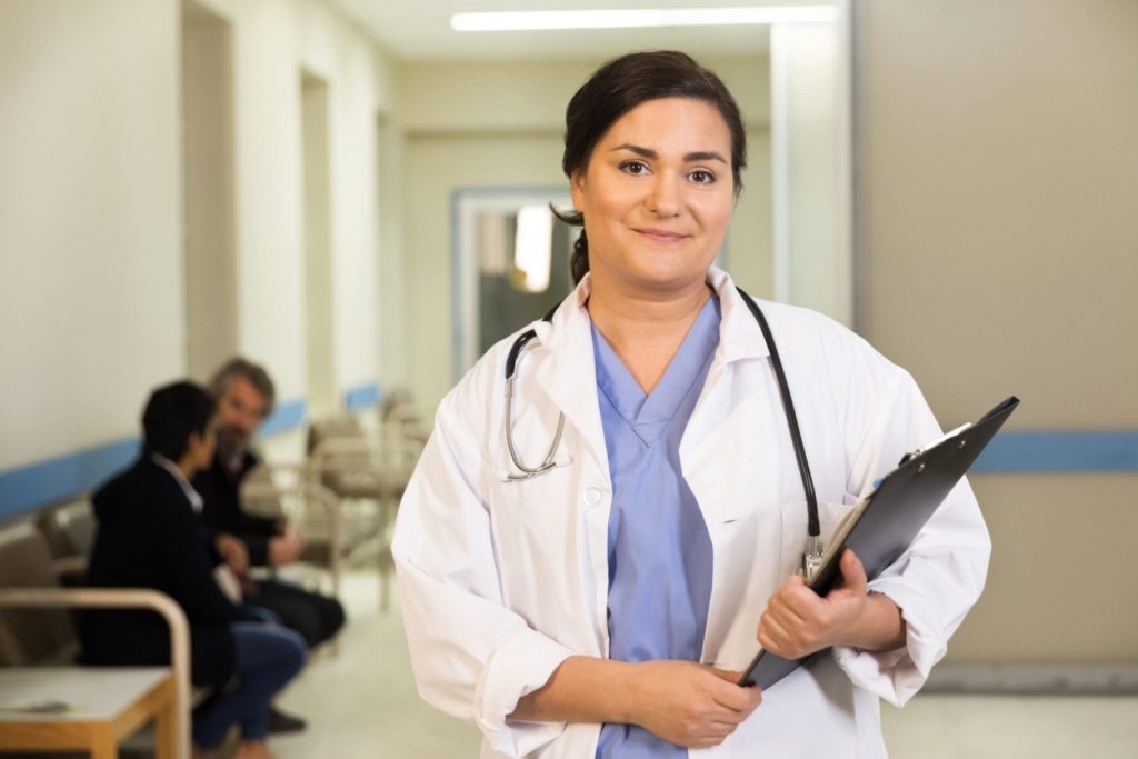 a-doctor-smiles-while-holding-her-clipboard-1.jpg